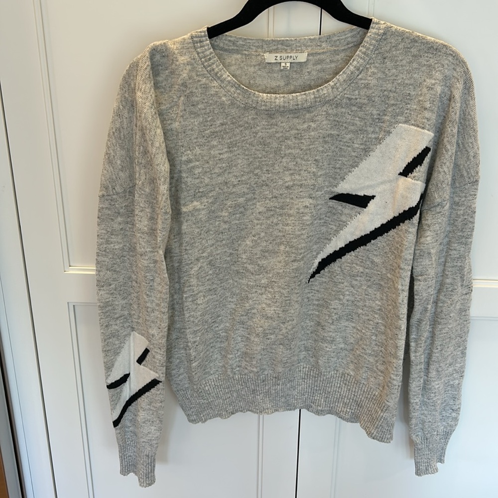 Z Supply grey sweater with white and black lightning bolts in size small